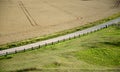 Rural road bisecting fields Royalty Free Stock Photo