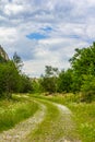 Rural road with small vegetation and cliffs Royalty Free Stock Photo