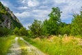 Rural road with small vegetation and cliffs Royalty Free Stock Photo