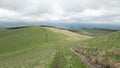 Rural road among the hills. Cloudy day. Nature walk. Peace and quiet Royalty Free Stock Photo