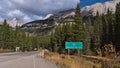 Rural road in Kananaskis Country, Canada with road sign showing the distance to Highway 40 (Kananaskis Trail). Royalty Free Stock Photo