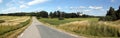 Rural road and landscape with the white Ekenas castle on a cloudy day, Sweden Royalty Free Stock Photo