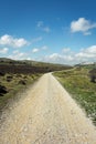 A rural road in the mountains during a spring day Royalty Free Stock Photo