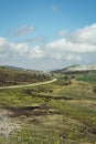 A rural road in the mountains during a spring day Royalty Free Stock Photo