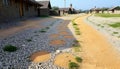 Rural road with puddles after rain, countryside path and reflective surface Generative AI Royalty Free Stock Photo