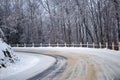 A snowy bend on a rural hillside road