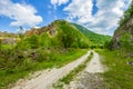 Rural road with small vegetation and cliffs Royalty Free Stock Photo