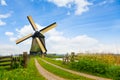 Rural road and windmill in Netherlands