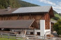 Rural  scene of an alpine barn with photovoltaic panels Royalty Free Stock Photo