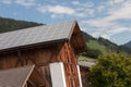 Rural scene  of an alpine barn with photovoltaic panels Royalty Free Stock Photo