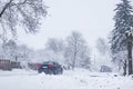 Rural scene with car driving  after heavy snowfall, transportation in winter, road covered in snow,  weather problems, country in Royalty Free Stock Photo