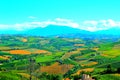 Scene in Carassai with fields sectoring the lands and impressive mountains Royalty Free Stock Photo