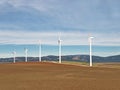 A rural scene with electric generator windmills