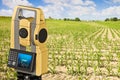 Rural scene with field and 3D rendering of a geodesic device, called Total Station Royalty Free Stock Photo