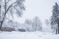 Rural scene after heavy snowfall, countryside in winter, road covered in snow,  weather problems Royalty Free Stock Photo