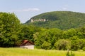 Rural scene with hill and rock panorama and house near village Wichsenstein in Franconian Switzerland, Germany