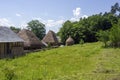 Rural scene with thatch roof buildings and loose hay stack, near Sibiu, Romania Royalty Free Stock Photo