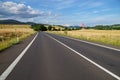 Rural scenery with empty road and traffic sign right bend ahead Royalty Free Stock Photo