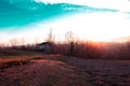 Old shed with rays of setting sun. Royalty Free Stock Photo