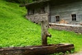 Rural scenery with wooden water well and a old alpine hut near Falzthurnalm. Achensee Lake area, Austria, Tirol Royalty Free Stock Photo