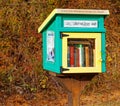 rural small green and yellow wooden Little Free Library case on post in Fall Royalty Free Stock Photo