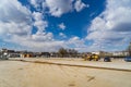Rural square construction site under blue sky and white clouds Royalty Free Stock Photo