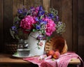 Rural still life with a bouquet of flowers and fruit. Royalty Free Stock Photo