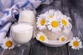 Rural still life. milk in a glass and chamomile on an old board Royalty Free Stock Photo