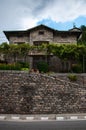 Rural stone house standing next to the road Royalty Free Stock Photo