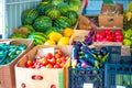 Rural street vegetable market. Watermelons, tomatoes, eggplants, cucumbers, onions, garlic are in boxes for sale Royalty Free Stock Photo