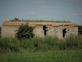 Ruins of old stone barn in summer field Royalty Free Stock Photo