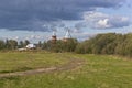 Rural summer landscape with wooden church. Church of the Nativity Prophet and Predtechi John the Baptist