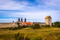 Rural summer view of an ancient medieval brick tower and defense wall surrounding the city of Visby Gotland, Sweden. Royalty Free Stock Photo