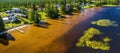 Rural Swedish landscape with coastal villages in forest. Wooden houses and barns on coast in sunny summer day, waterfront houses Royalty Free Stock Photo