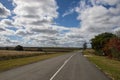 Rural Tarmac Country Road Bordered by Farm Land