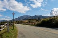 Rural tarmac road with speed limit sign through Aso-Kuju National Park on Kyushu Island, Japan.