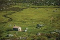 Rural van in front of small house on green fields Royalty Free Stock Photo