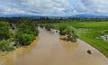 Rural village along river water at high levels with flooding meadows a cloudy sky Royalty Free Stock Photo