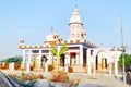 A rural village landscape consisting of lush greenery, a Hindu temple