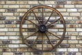 Rural wagon wheel on a brick wall