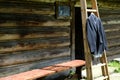 Rural wedding concept. man's jacket hangs on a wooden ladder near the barn.