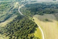 Rural winding road through fields and forest. birds eyes view