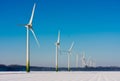 Rural winter landscape with big windturbines