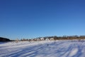 Rural winter landscape with a field snow and the blue sky Royalty Free Stock Photo