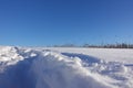 Rural winter landscape with a field snow and the blue sky Royalty Free Stock Photo