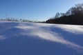 Rural winter landscape with a field snow and the blue sky Royalty Free Stock Photo