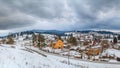 Rural winter landscape - view of the village Vorokhta with the railway in valley Prut River the Carpathian Mountains