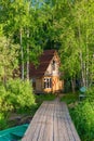 Rural wooden fisherman`s house on the shore of a lake and a wood Royalty Free Stock Photo