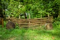 Rural wooden palisade rustic fence garden spring time vivid green foliage nature background scenic view sunny day weather