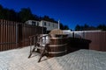 Rural wooden water hot tub with stairs garden yard. . night and starry sky